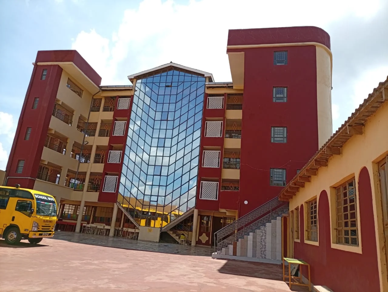 The modern glass-fronted block with a school bus