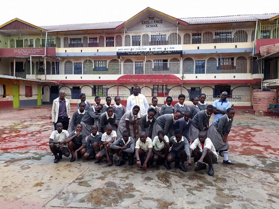 Staff and students in front of the school